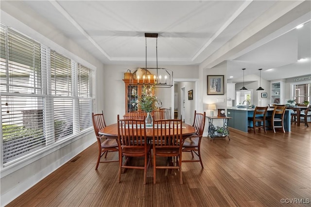 11561 Smokehouse Dr, Amelia Courthouse, VA 23002 - dining room with healthy amount of natural light, dark wood-style flooring, a tray ceiling, and a chandelier