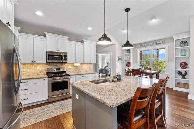 11561 Smokehouse Dr, Amelia Courthouse, VA 23002 - kitchen with appliances with stainless steel finishes, decorative backsplash, light stone countertops, white cabinetry, and dark wood-style floors