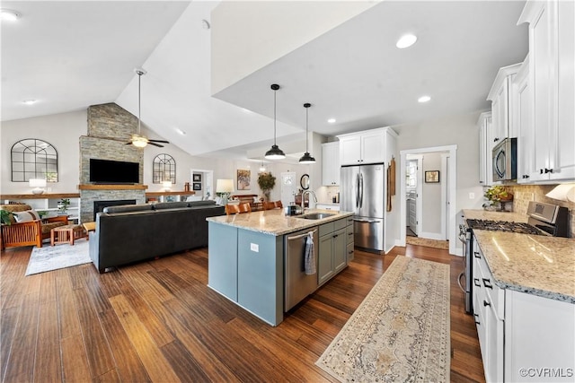 11561 Smokehouse Dr, Amelia Courthouse, VA 23002 - kitchen featuring appliances with stainless steel finishes, open floor plan, white cabinets, light stone countertops, and backsplash
