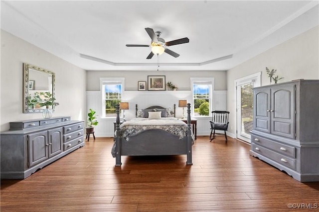 11561 Smokehouse Dr, Amelia Courthouse, VA 23002 - bedroom with a tray ceiling, dark wood-style flooring, and a ceiling fan