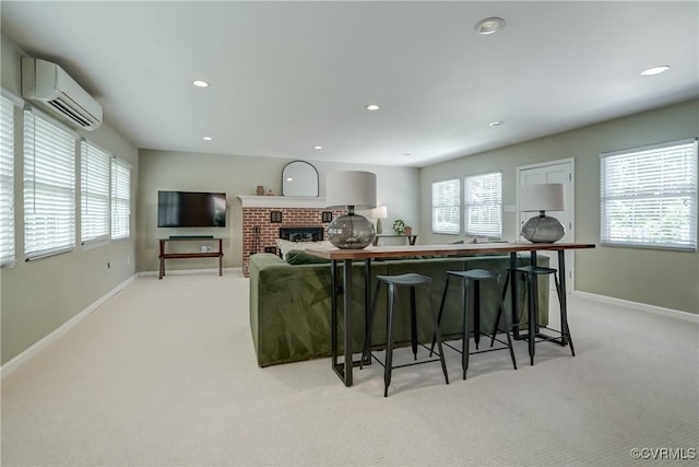 4824 Coleman Rd, Richmond, VA 23230 - living area featuring a wall mounted air conditioner, light carpet, recessed lighting, and a brick fireplace