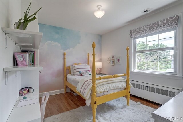 4824 Coleman Rd, Richmond, VA 23230 - bedroom with radiator heating unit and wood finished floors