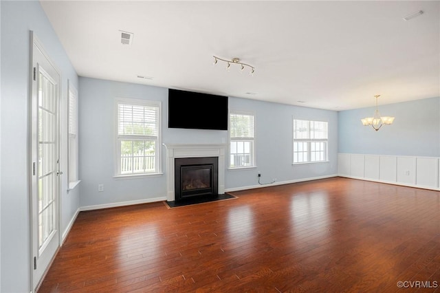 3316 Kennington Park Rd, King William, VA 23009 - unfurnished living room featuring a fireplace with flush hearth, a chandelier, and dark wood-type flooring