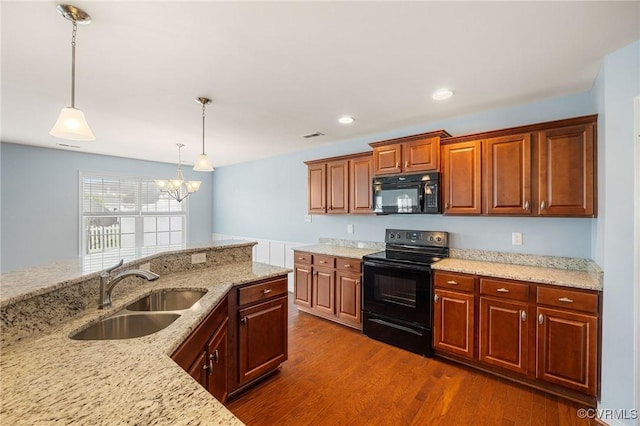 3316 Kennington Park Rd, King William, VA 23009 - kitchen with black appliances, a chandelier, dark wood finished floors, light stone counters, and recessed lighting