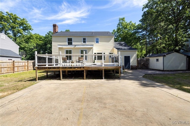 13119 Glenmeadow Ct, Midlothian, VA 23114 - rear view of property featuring a wooden deck, a storage unit, and a chimney