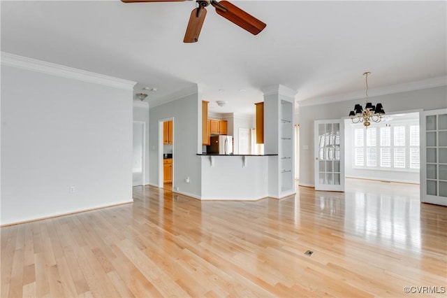 600 Krim Point Loop, Midlothian, VA 23114 - unfurnished living room with crown molding, a chandelier, light wood-style flooring, and a ceiling fan