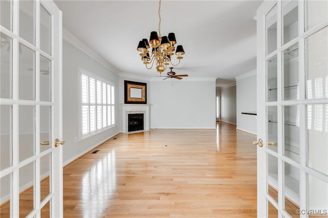 600 Krim Point Loop, Midlothian, VA 23114 - unfurnished living room featuring a chandelier, ornamental molding, light wood-style flooring, a fireplace, and french doors