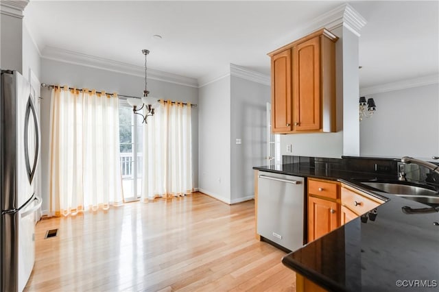 600 Krim Point Loop, Midlothian, VA 23114 - kitchen with stainless steel appliances, dark countertops, light wood finished floors, ornamental molding, and decorative light fixtures