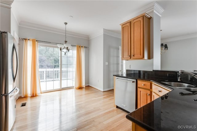 600 Krim Point Loop, Midlothian, VA 23114 - kitchen with appliances with stainless steel finishes, a chandelier, dark countertops, light wood finished floors, and crown molding