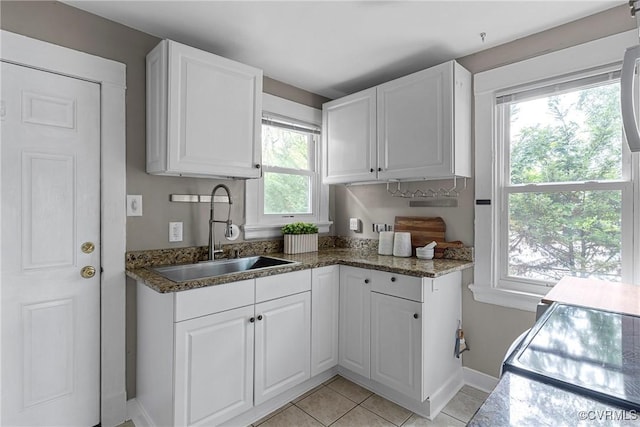 1708 Westwood Ave, Richmond, VA 23227 - kitchen featuring white cabinets, light tile patterned flooring, dark stone countertops, and electric stove