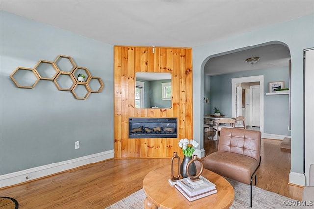 1708 Westwood Ave, Richmond, VA 23227 - living room with arched walkways, wood finished floors, and a fireplace