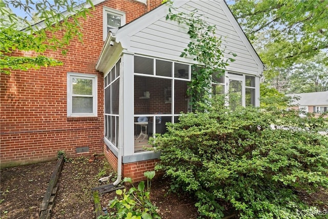 1012 Ridgecliff Dr, Richmond, VA 23224 - view of side of property with a sunroom, brick siding, and crawl space