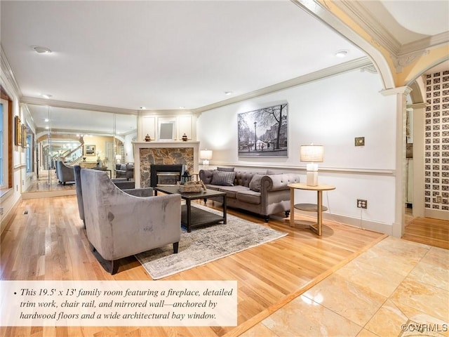 2821 Newquay Ln, North Chesterfield, VA 23236 - living room with ornamental molding, a stone fireplace, decorative columns, and arched walkways