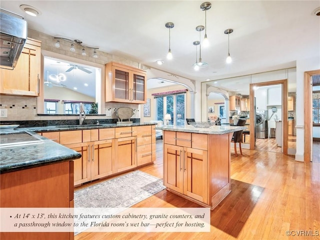 2821 Newquay Ln, North Chesterfield, VA 23236 - kitchen with ceiling fan, arched walkways, light wood-type flooring, and decorative backsplash