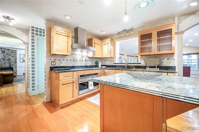 2821 Newquay Ln, North Chesterfield, VA 23236 - kitchen with oven, wall chimney exhaust hood, ornate columns, arched walkways, and recessed lighting