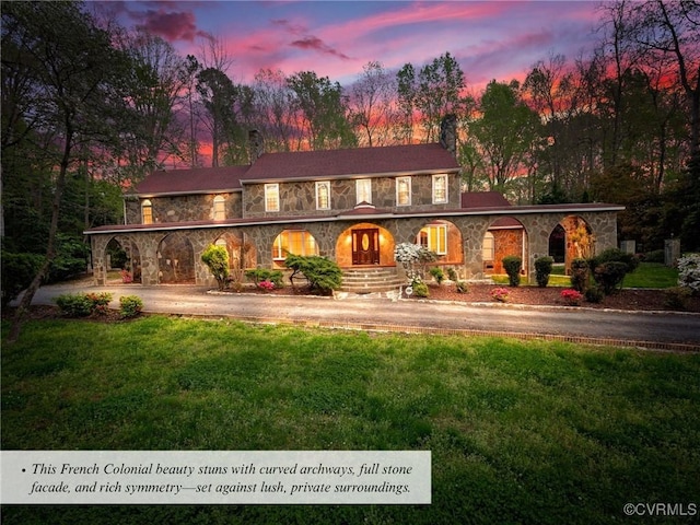 2821 Newquay Ln, North Chesterfield, VA 23236 - back of house featuring stone siding, a yard, and a chimney