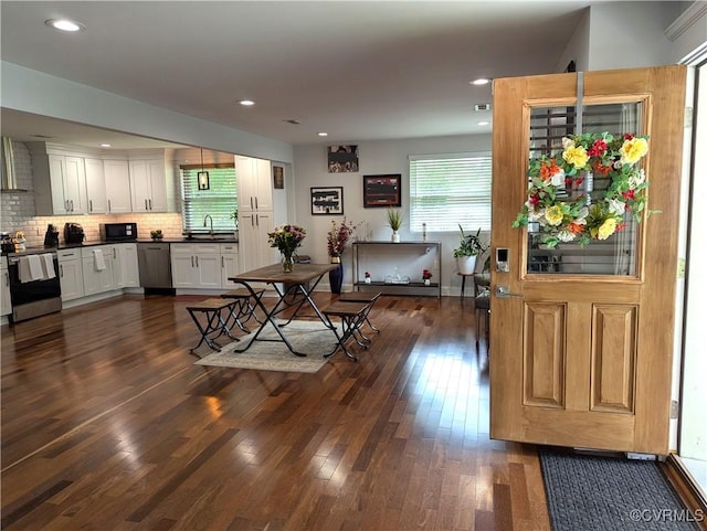 186 Piedmont Ave, Colonial Heights, VA 23834 - kitchen with appliances with stainless steel finishes, dark wood-type flooring, dark countertops, tasteful backsplash, and white cabinets