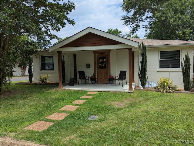 186 Piedmont Ave, Colonial Heights, VA 23834 - rear view of house featuring concrete block siding, a lawn, covered porch, and a shingled roof
