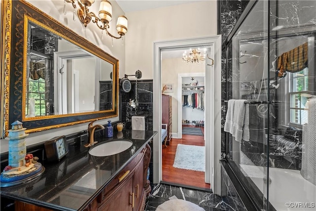 16520 Church St, Amelia Courthouse, VA 23002 - bathroom featuring a chandelier, vanity, marble look tiles, an enclosed shower, and a bathtub