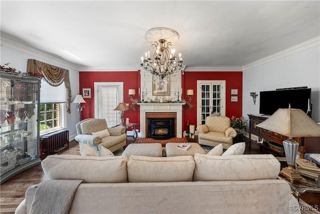 16520 Church St, Amelia Courthouse, VA 23002 - living room with a chandelier, a brick fireplace, crown molding, wood finished floors, and radiator