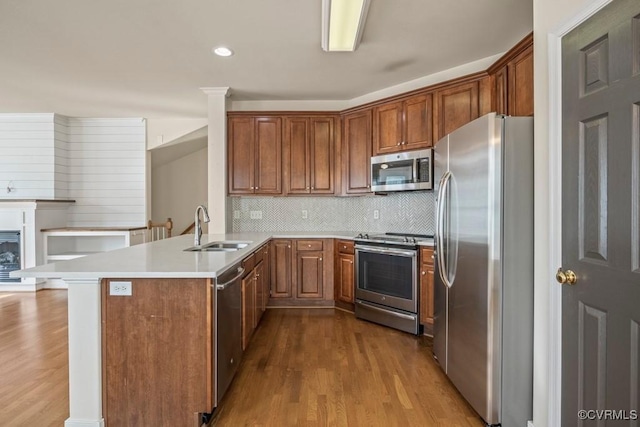 4133 San Marco Dr Unit 4133, Glen Allen, VA 23060 - kitchen featuring appliances with stainless steel finishes, wood finished floors, a peninsula, tasteful backsplash, and light countertops