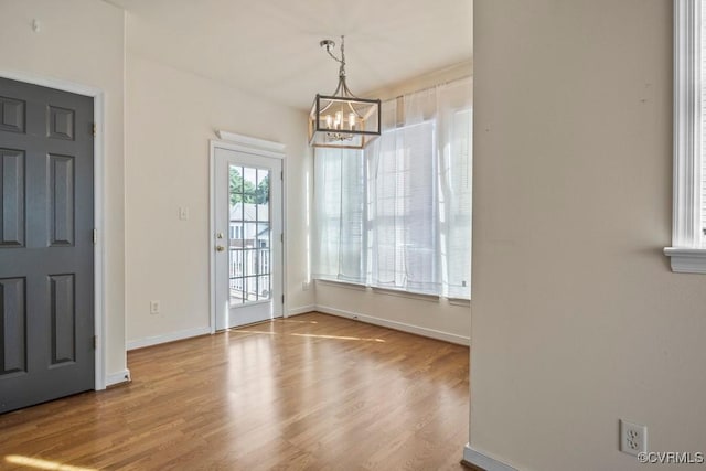4133 San Marco Dr Unit 4133, Glen Allen, VA 23060 - unfurnished dining area with a chandelier and wood finished floors