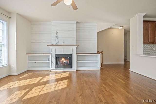 4133 San Marco Dr Unit 4133, Glen Allen, VA 23060 - unfurnished living room with plenty of natural light, wood finished floors, ceiling fan, and a glass covered fireplace