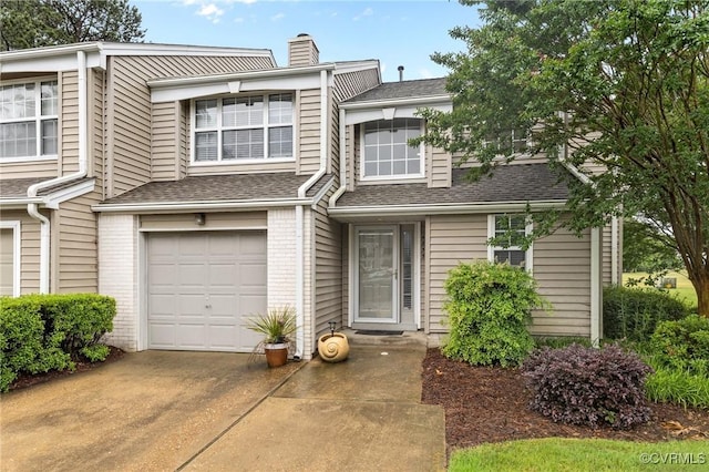 4855 Cypress Point Cir Unit 104, Virginia Beach, VA 23455 - view of property with a garage, a chimney, a shingled roof, concrete driveway, and brick siding