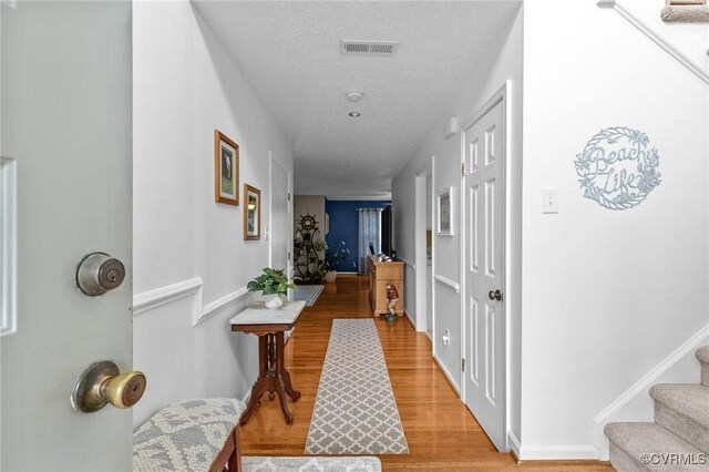 4855 Cypress Point Cir Unit 104, Virginia Beach, VA 23455 - hall with light wood-type flooring, stairs, and a textured ceiling