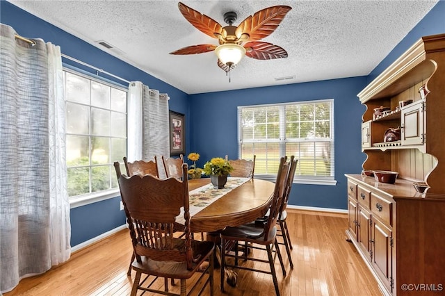 4855 Cypress Point Cir Unit 104, Virginia Beach, VA 23455 - dining area featuring healthy amount of natural light, light wood-style floors, a textured ceiling, and a ceiling fan