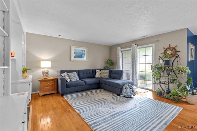 4855 Cypress Point Cir Unit 104, Virginia Beach, VA 23455 - living room with a textured ceiling and light wood-style flooring