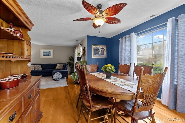 4855 Cypress Point Cir Unit 104, Virginia Beach, VA 23455 - dining space featuring a textured ceiling, light wood-type flooring, and ceiling fan