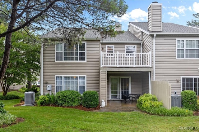 4855 Cypress Point Cir Unit 104, Virginia Beach, VA 23455 - back of property with a balcony, a yard, a patio, a chimney, and roof with shingles
