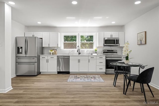 419 Marblethorpe Rd, North Chesterfield, VA 23236 - kitchen featuring stainless steel appliances, white cabinetry, recessed lighting, decorative backsplash, and light countertops