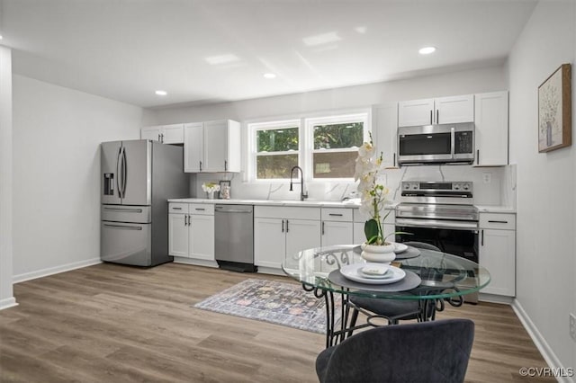 419 Marblethorpe Rd, North Chesterfield, VA 23236 - kitchen with appliances with stainless steel finishes, light wood finished floors, light countertops, recessed lighting, and white cabinets