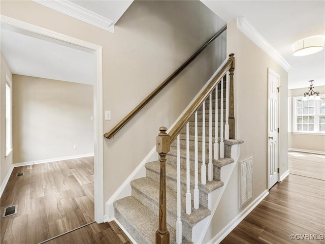 12213 Collinstone Pl, Glen Allen, VA 23059 - stairway with wood finished floors, crown molding, and a chandelier