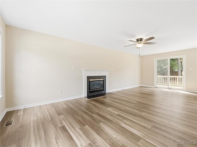 12213 Collinstone Pl, Glen Allen, VA 23059 - unfurnished living room with light wood-style flooring, a ceiling fan, and a fireplace with flush hearth