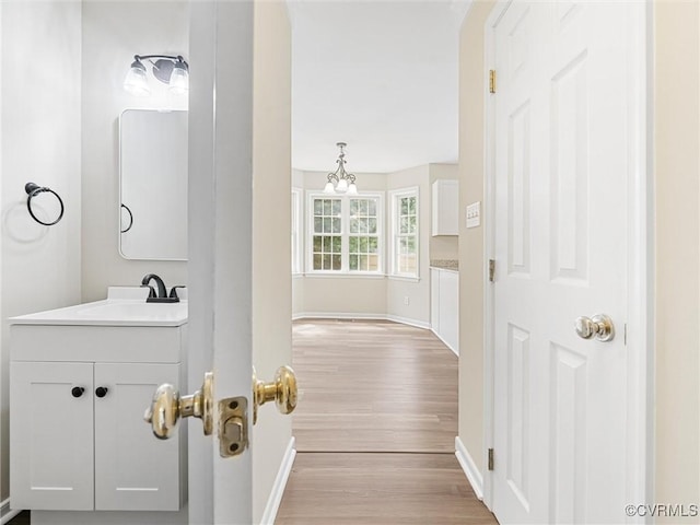 12213 Collinstone Pl, Glen Allen, VA 23059 - corridor featuring wood finished floors and a chandelier