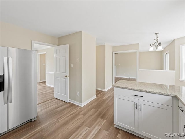 12213 Collinstone Pl, Glen Allen, VA 23059 - kitchen with stainless steel refrigerator with ice dispenser, light wood-style floors, hanging light fixtures, light stone counters, and a chandelier