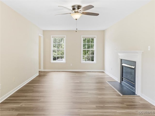 12213 Collinstone Pl, Glen Allen, VA 23059 - unfurnished living room featuring ceiling fan, wood finished floors, and a glass covered fireplace