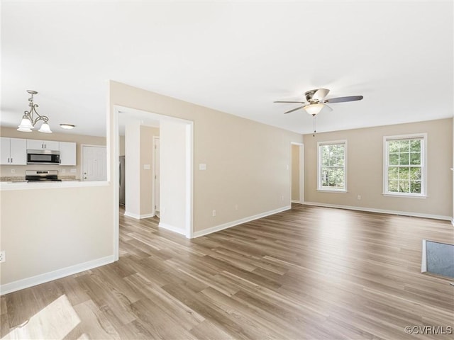 12213 Collinstone Pl, Glen Allen, VA 23059 - unfurnished living room with light wood finished floors, a chandelier, and ceiling fan