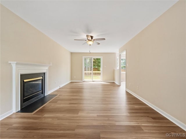 12213 Collinstone Pl, Glen Allen, VA 23059 - unfurnished living room featuring ceiling fan, wood finished floors, and a glass covered fireplace
