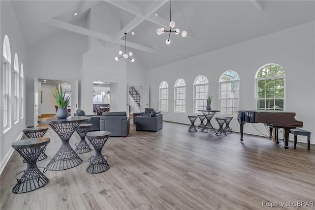 3315 Windmill Point Rd, White Stone, VA 22578 - living room featuring high vaulted ceiling, a chandelier, beam ceiling, wood finished floors, and stairway
