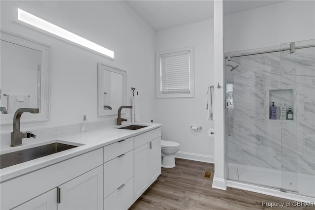 3315 Windmill Point Rd, White Stone, VA 22578 - bathroom featuring double vanity, a marble finish shower, and wood finished floors