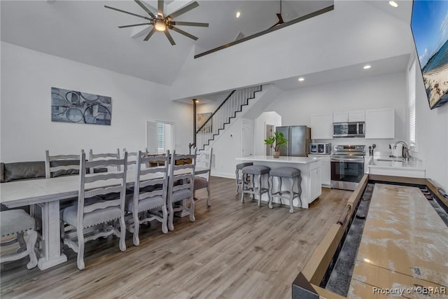 3315 Windmill Point Rd, White Stone, VA 22578 - dining area featuring high vaulted ceiling, ceiling fan, light wood finished floors, stairs, and recessed lighting