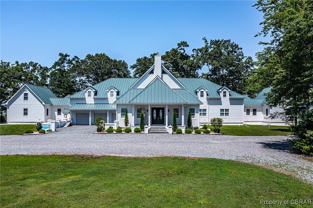 3315 Windmill Point Rd, White Stone, VA 22578 - view of front of home with gravel driveway, a standing seam roof, a chimney, a front yard, and a porch
