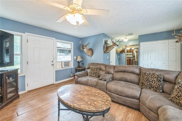 1305 Pea Ridge Rd, King & Queen, VA 23023 - living area featuring light wood-style flooring, a textured ceiling, ceiling fan, and cooling unit
