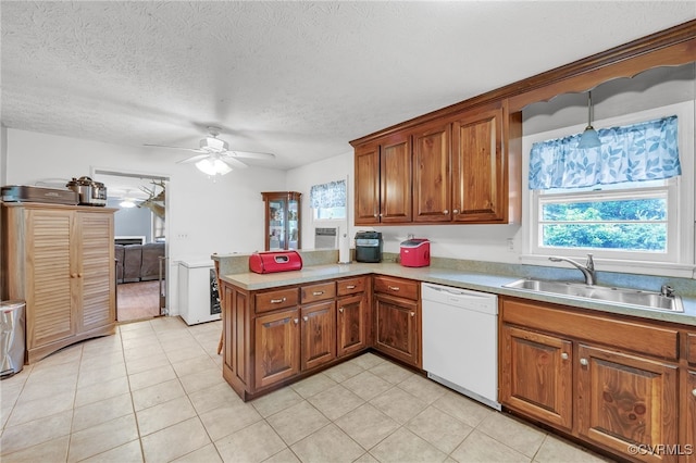 1305 Pea Ridge Rd, King & Queen, VA 23023 - kitchen with white dishwasher, brown cabinetry, a peninsula, ceiling fan, and a textured ceiling