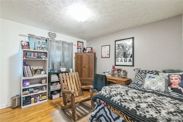 1305 Pea Ridge Rd, King & Queen, VA 23023 - bedroom with wood finished floors and a textured ceiling