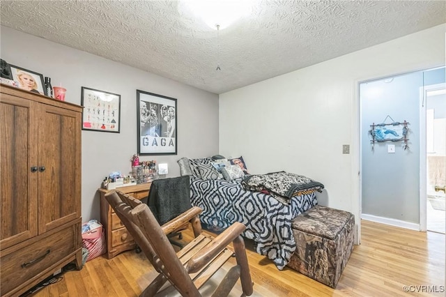 1305 Pea Ridge Rd, King & Queen, VA 23023 - bedroom with light wood-style floors and a textured ceiling